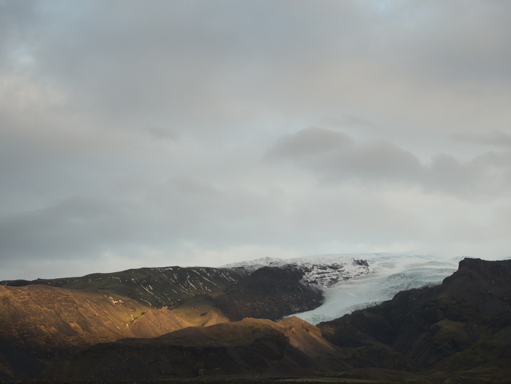 a view of a mountain range with a glacier in the distance