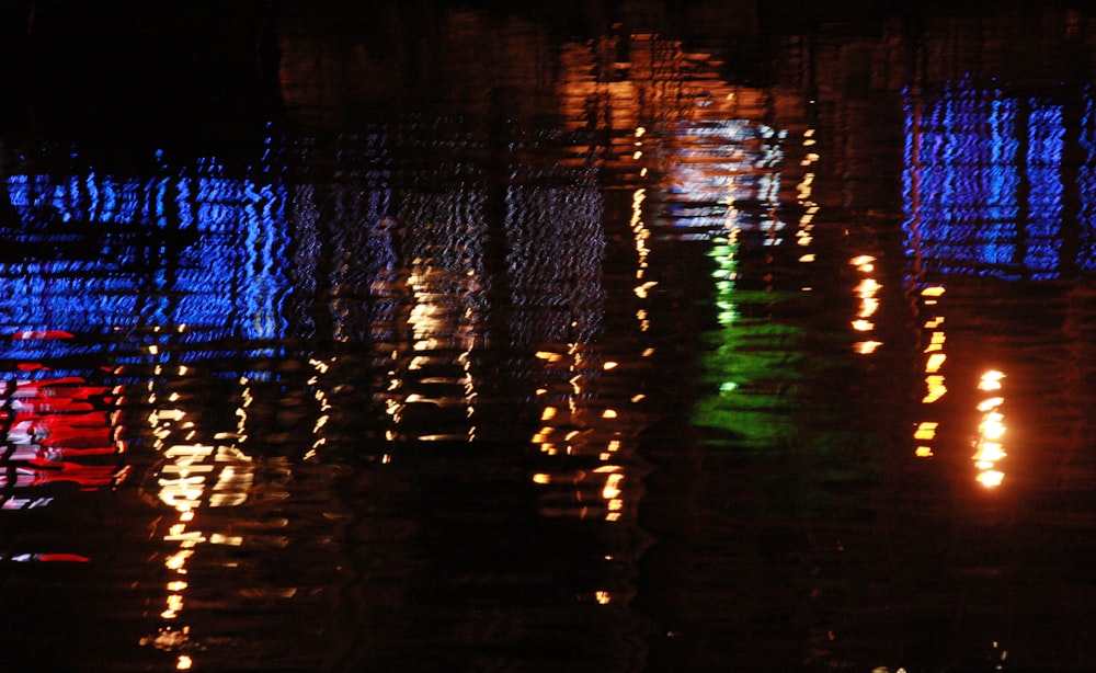 a group of lights reflecting off of a body of water