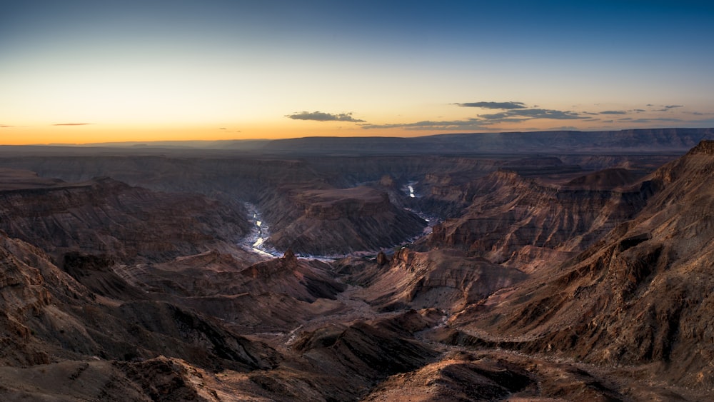 the sun is setting over the mountains in the desert