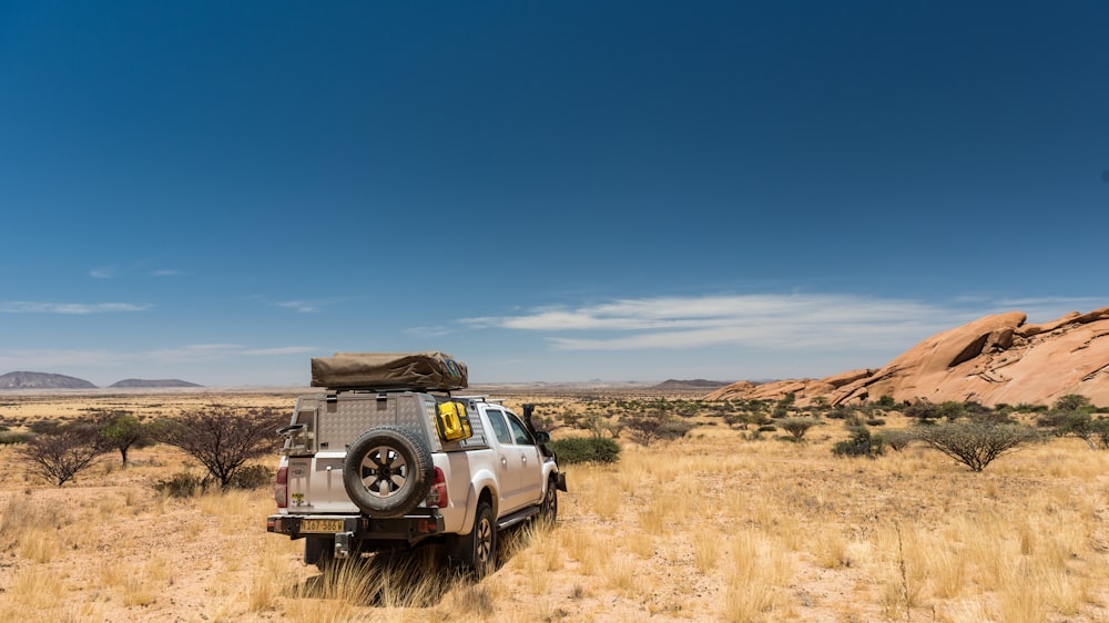 a truck is parked in the middle of the desert