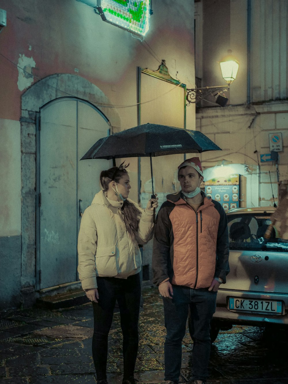 a man and a woman standing under an umbrella