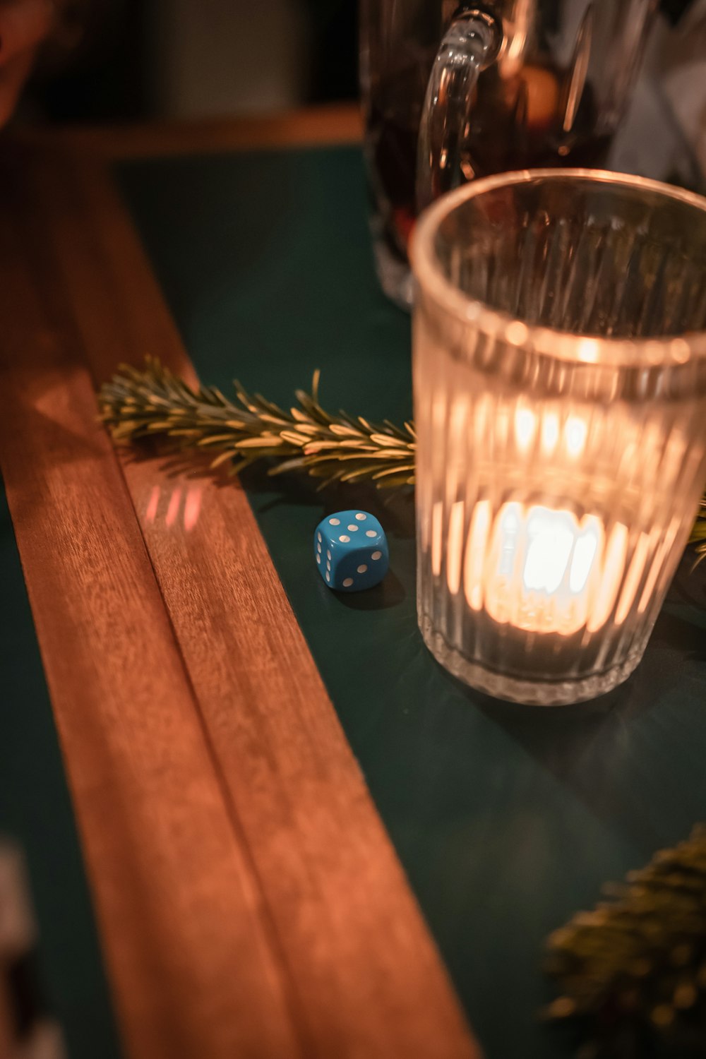a glass of water and a dice on a table