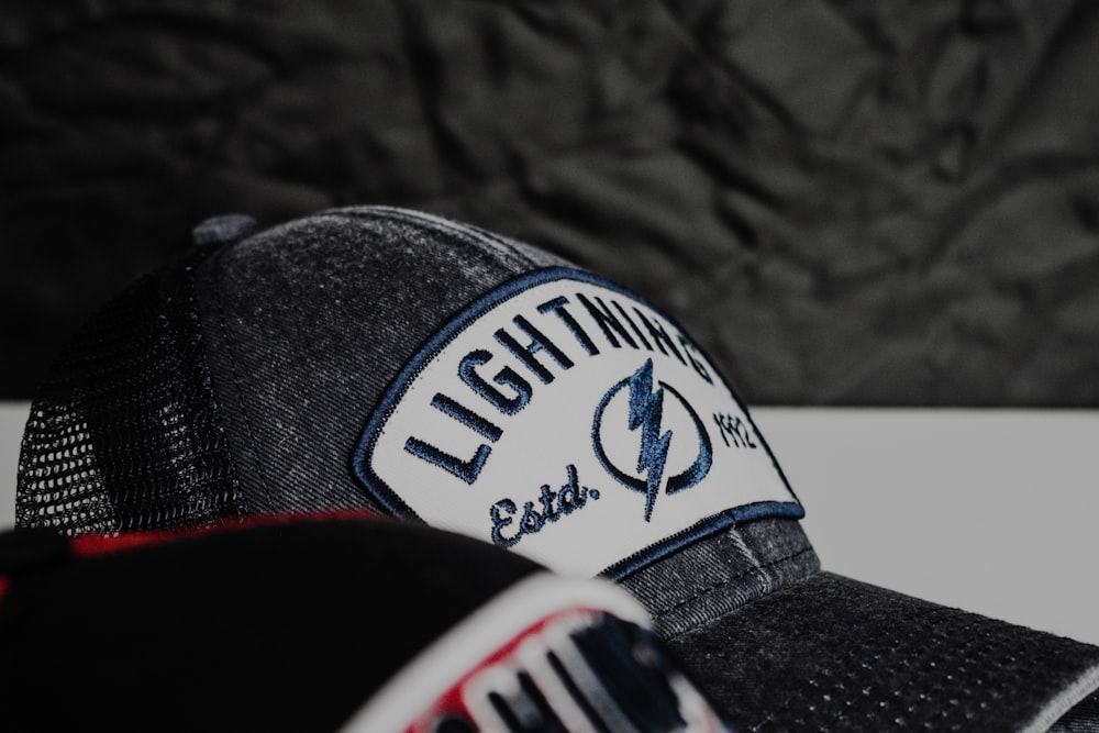 a baseball cap with a lightning patch on it