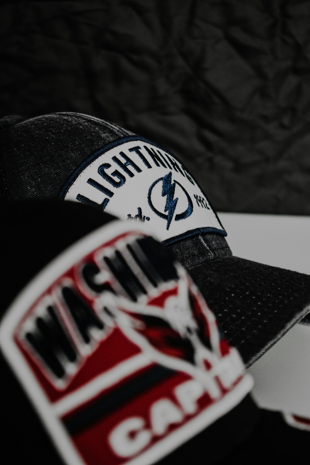 two hats sitting on top of a white table