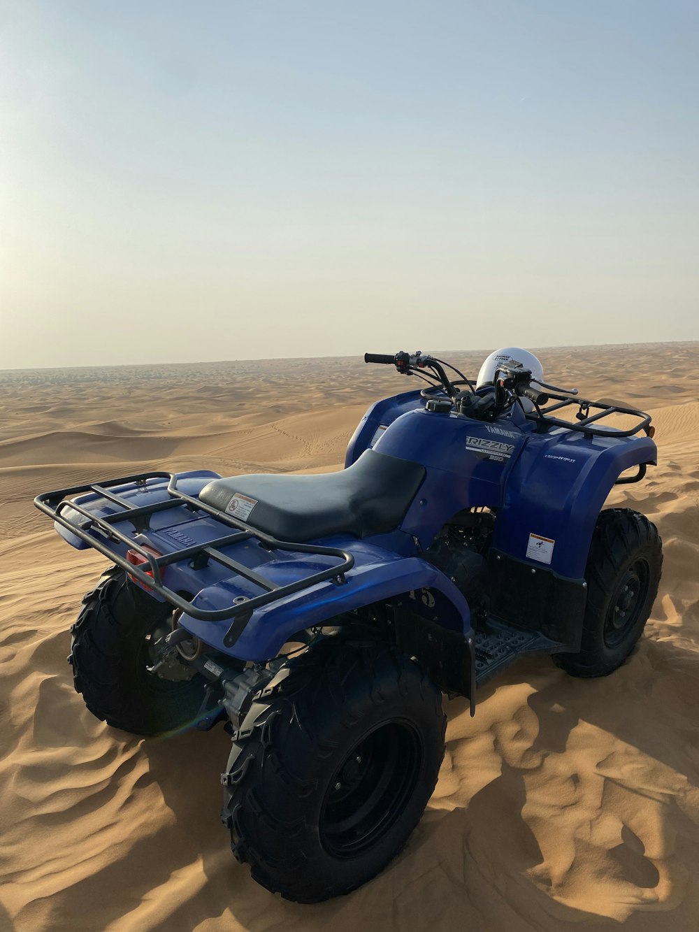 a blue four - wheeler in the middle of the desert