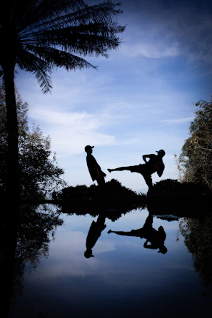 a couple of people that are standing in the water