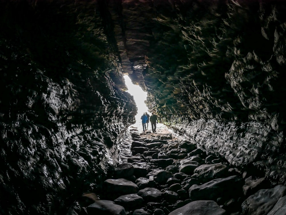 a couple of people that are standing in a cave