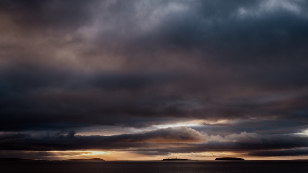 a large body of water under a cloudy sky