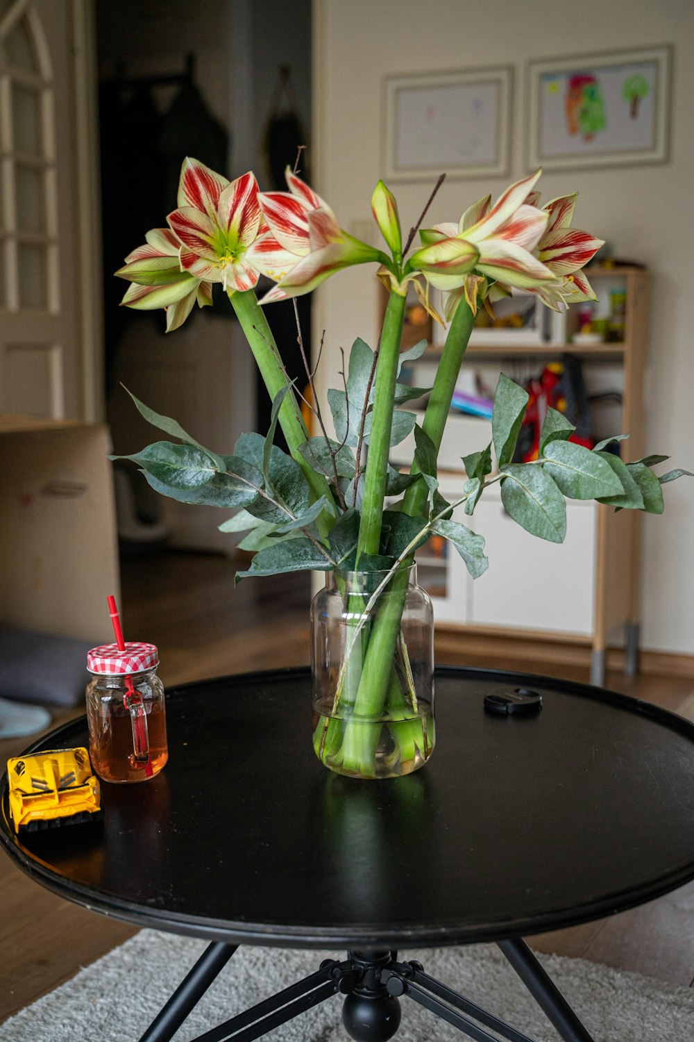 a table with a vase of flowers on top of it