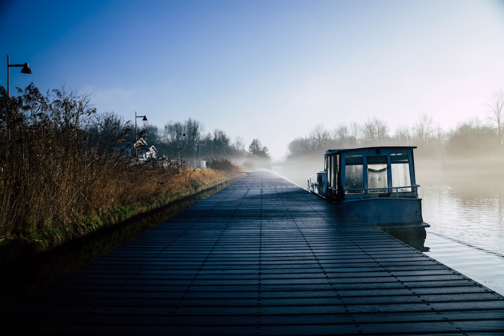 a boat is docked on a foggy lake