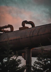a large pipe sitting on top of a metal pipe