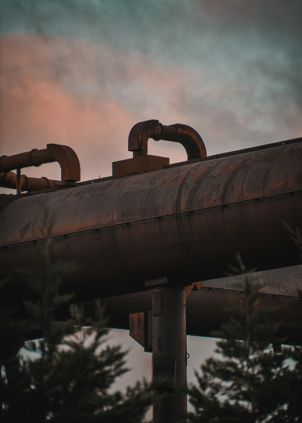 a large pipe sitting on top of a metal pipe