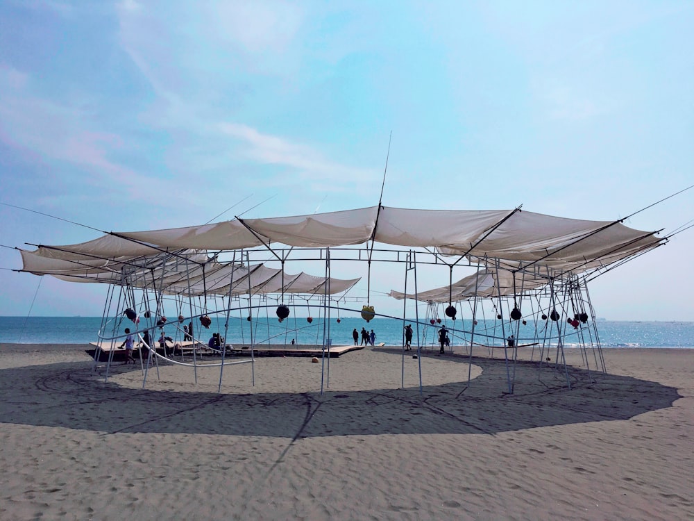 a group of umbrellas sitting on top of a sandy beach