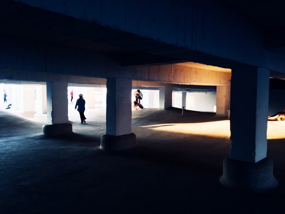 a group of people walking through a parking garage