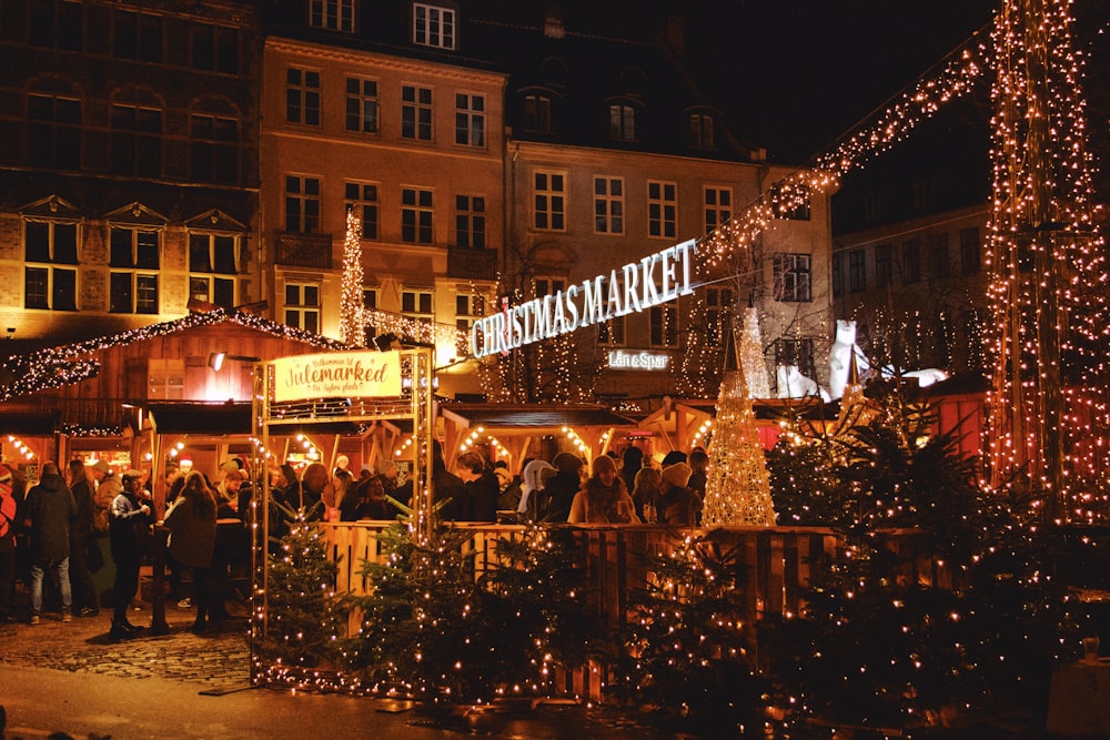 a group of people standing around a christmas market