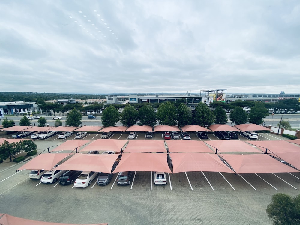 a parking lot filled with lots of cars under a cloudy sky