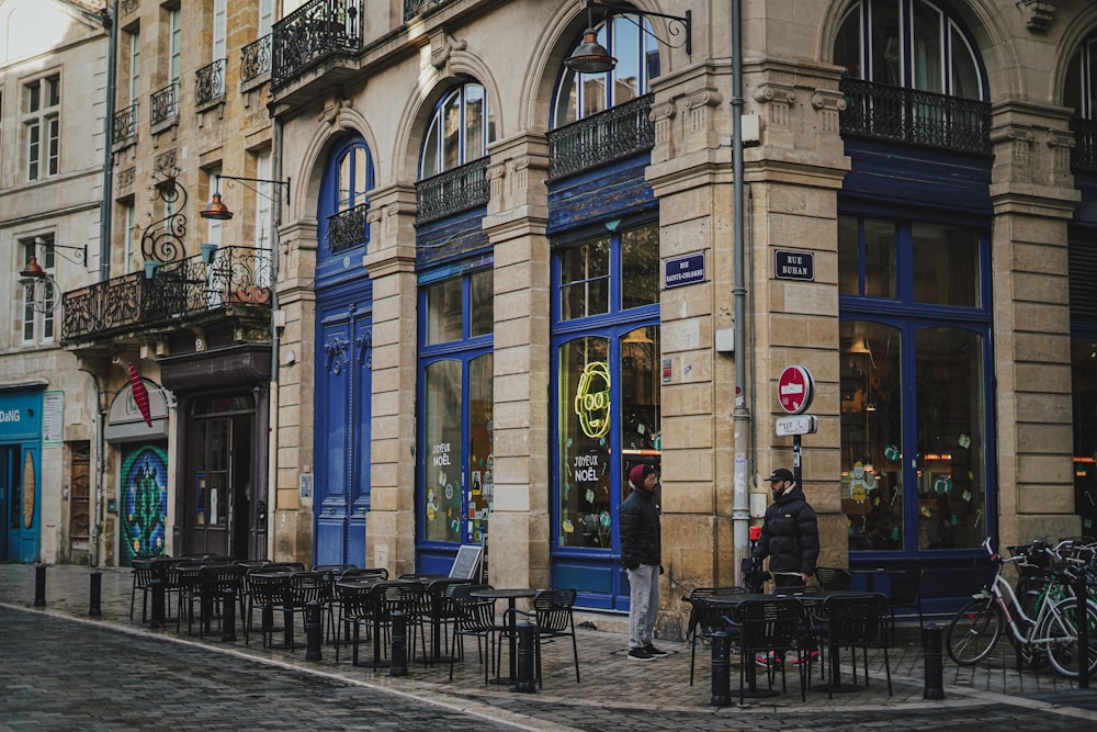 a man sitting on a bench in front of a building