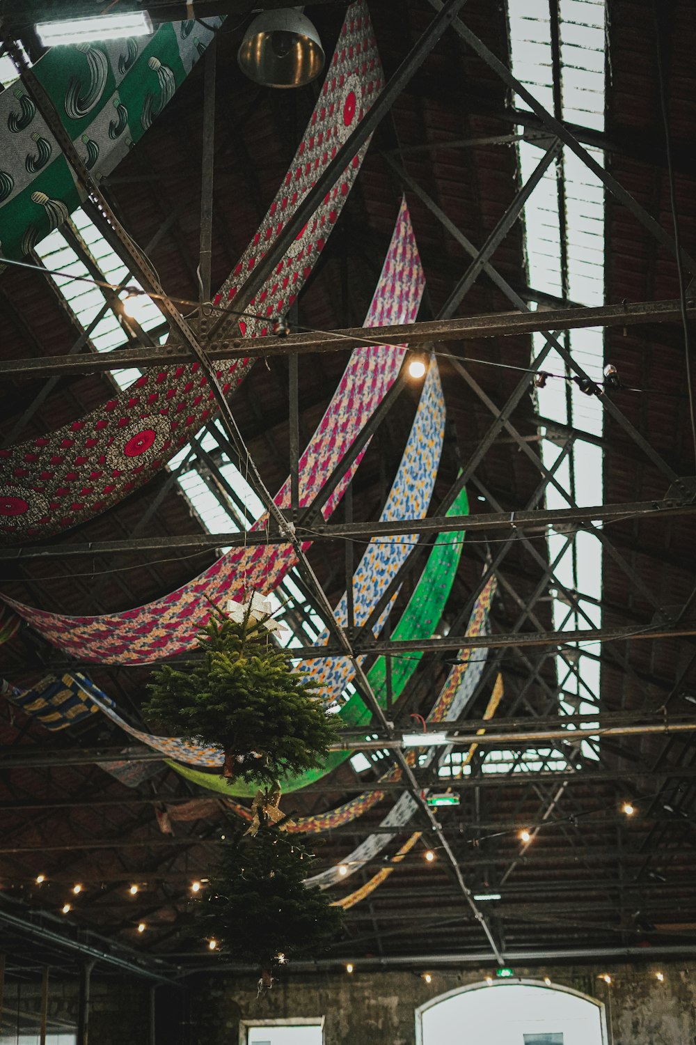 a group of flags hanging from the ceiling of a building