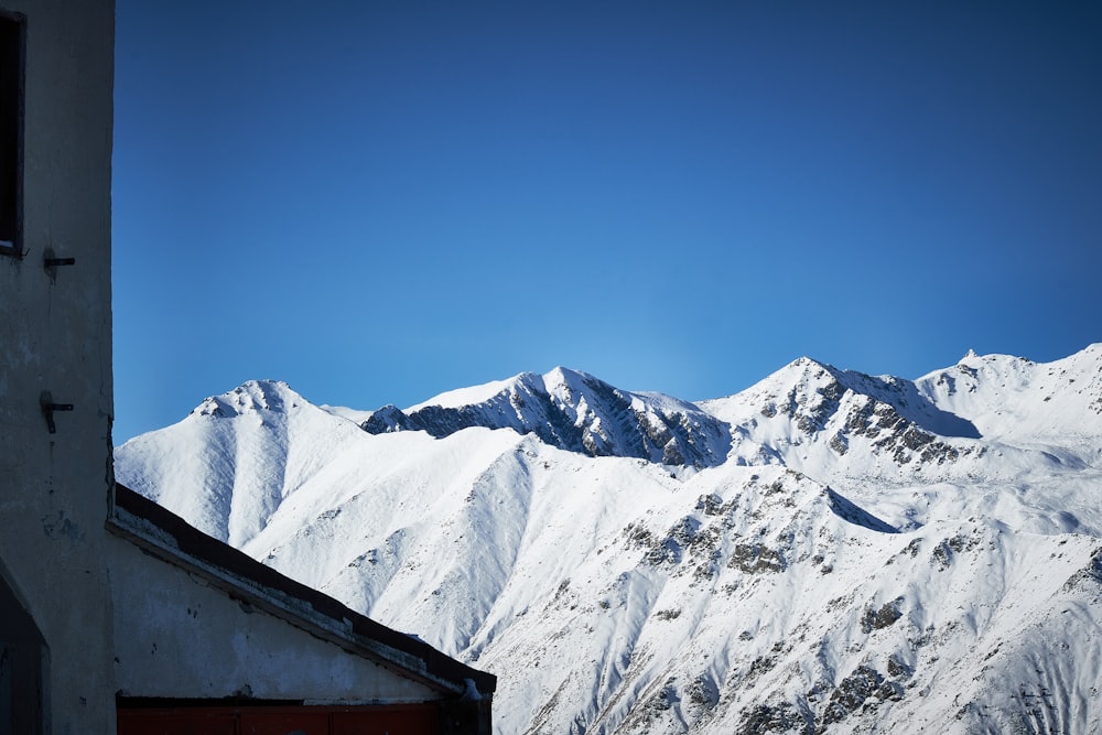 a view of a snowy mountain range from a building