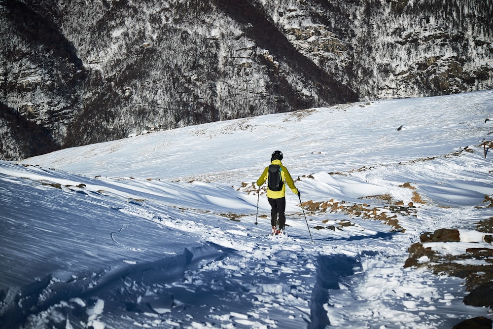 a person on skis in the snow on a mountain
