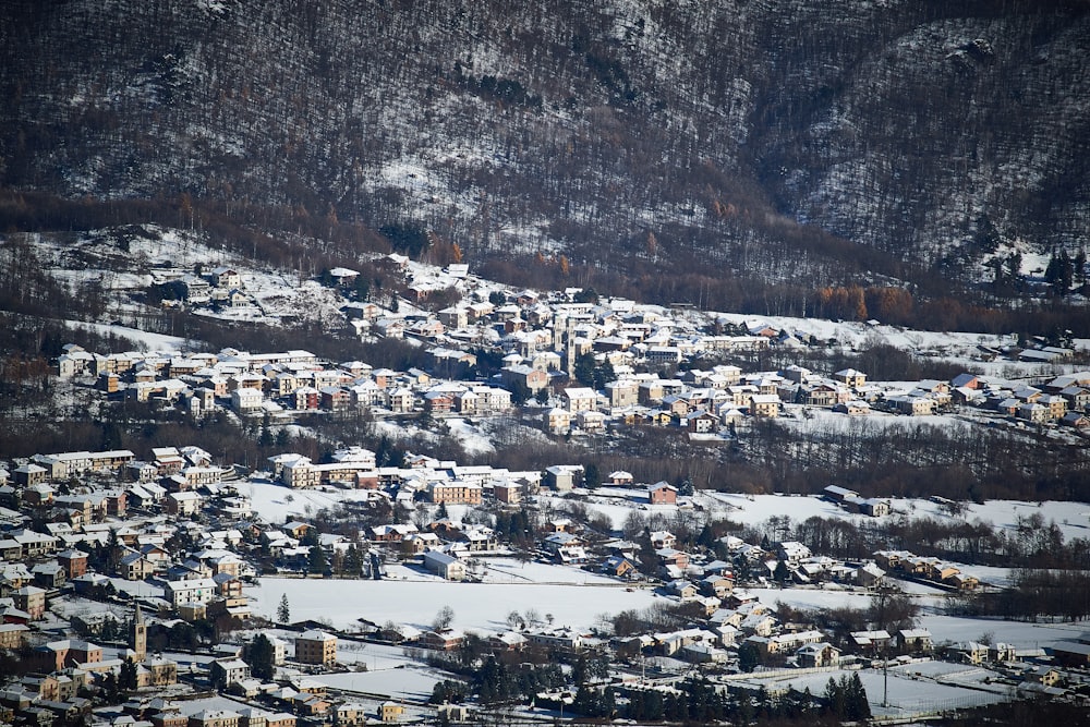 a small town in the mountains covered in snow