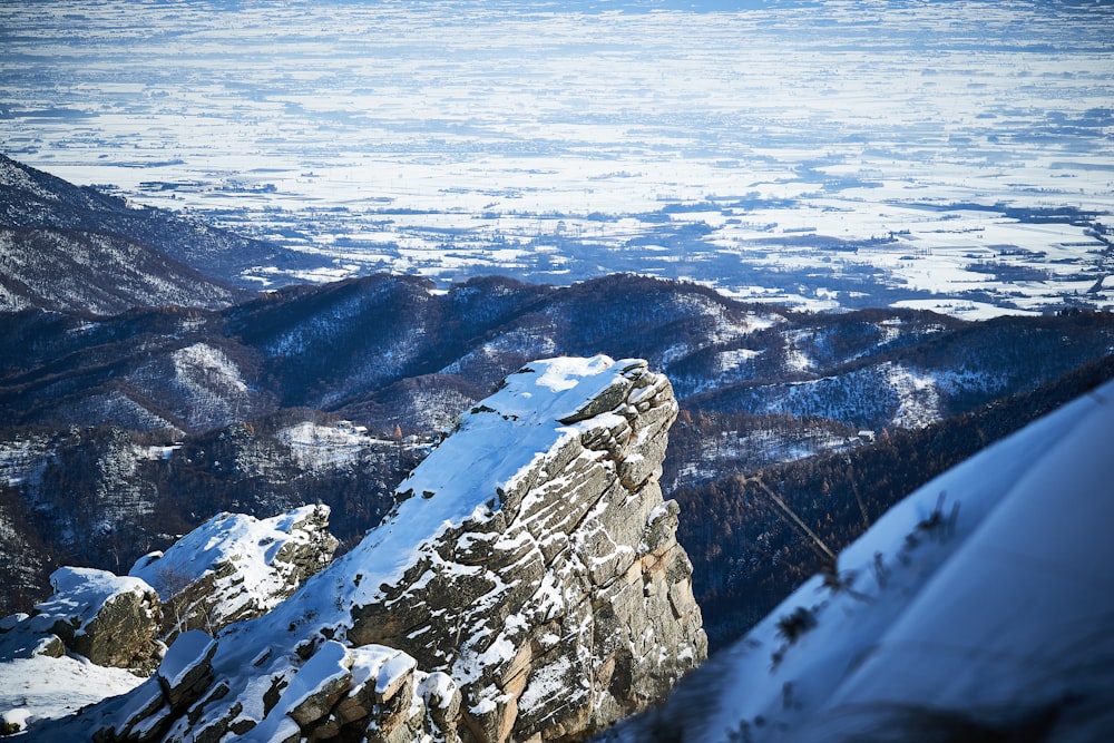 a person standing on top of a snow covered mountain