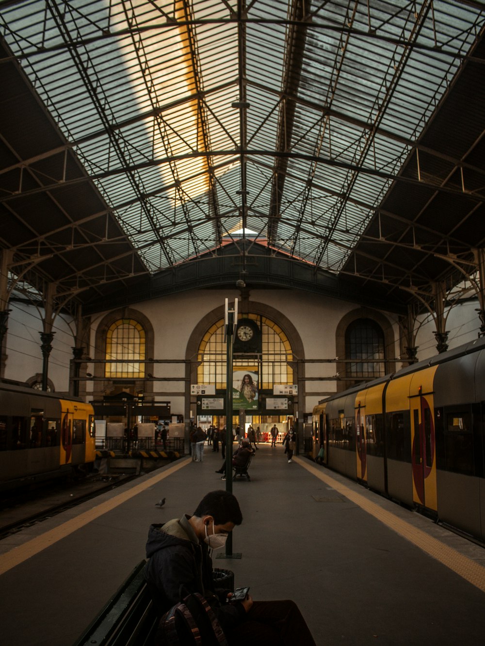 a man sitting on a bench in a train station
