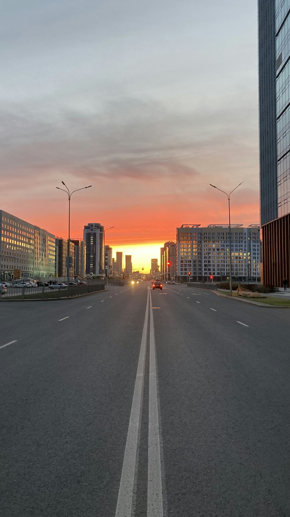the sun is setting over a city street