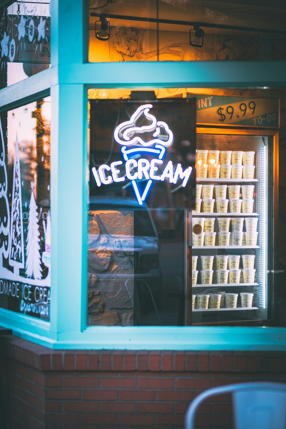 a ice cream shop with a neon sign in the window