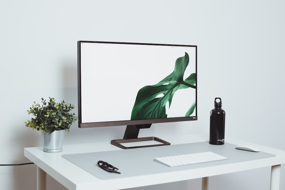 a computer monitor sitting on top of a white desk