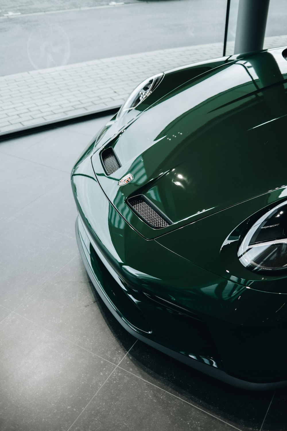 a green sports car parked in a garage