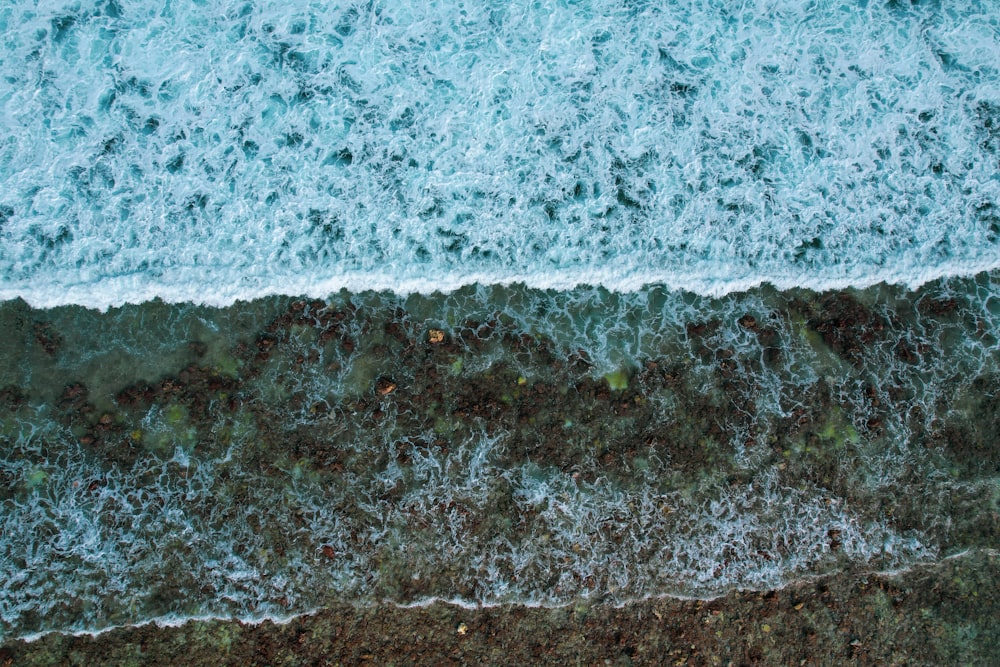 an aerial view of the ocean with waves