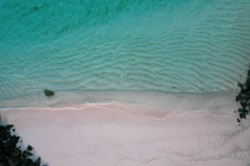 an aerial view of a sandy beach and water