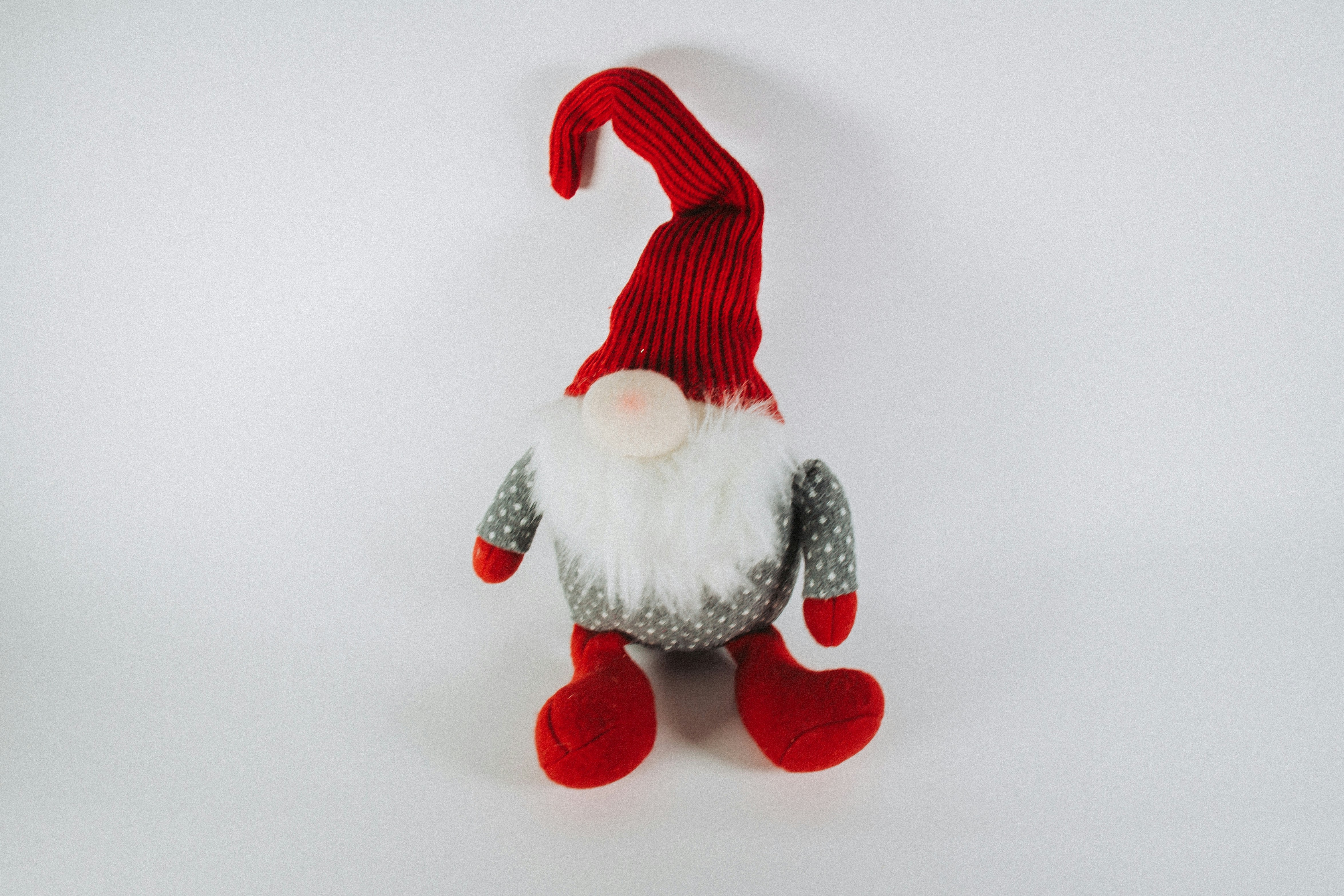 a red and white gnome doll with a red hat