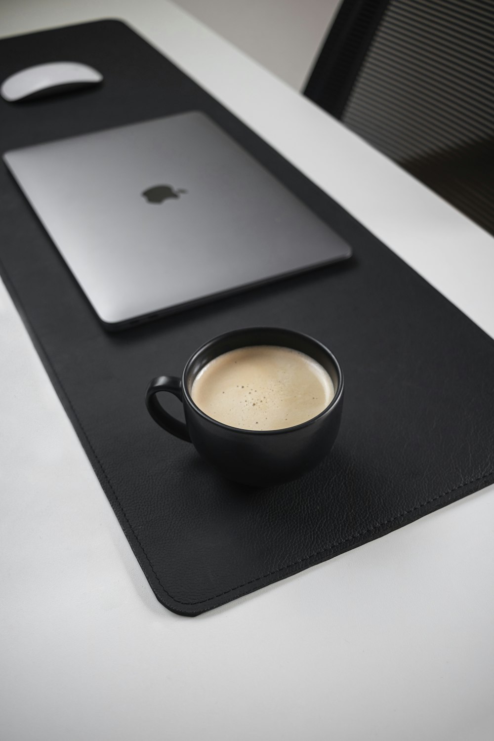 a cup of coffee sitting on top of a black tray