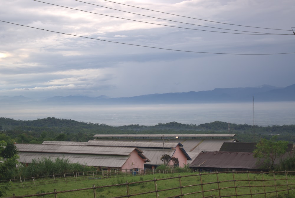 a farm with a lot of farm buildings in the background