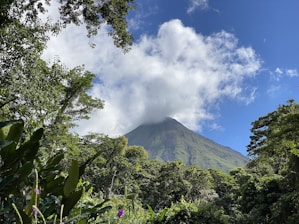a view of a mountain with a cloud in the sky