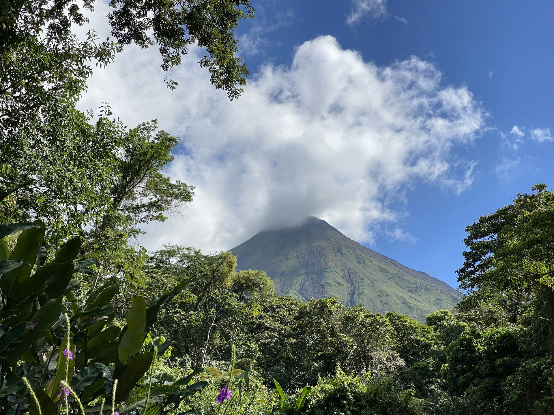 a view of a mountain with a cloud in the sky