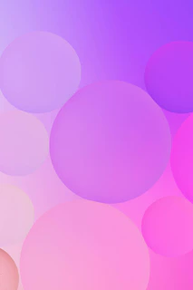A serene, softly glowing abstract background in gentle pink and purple hues with delicate rounded shapes.