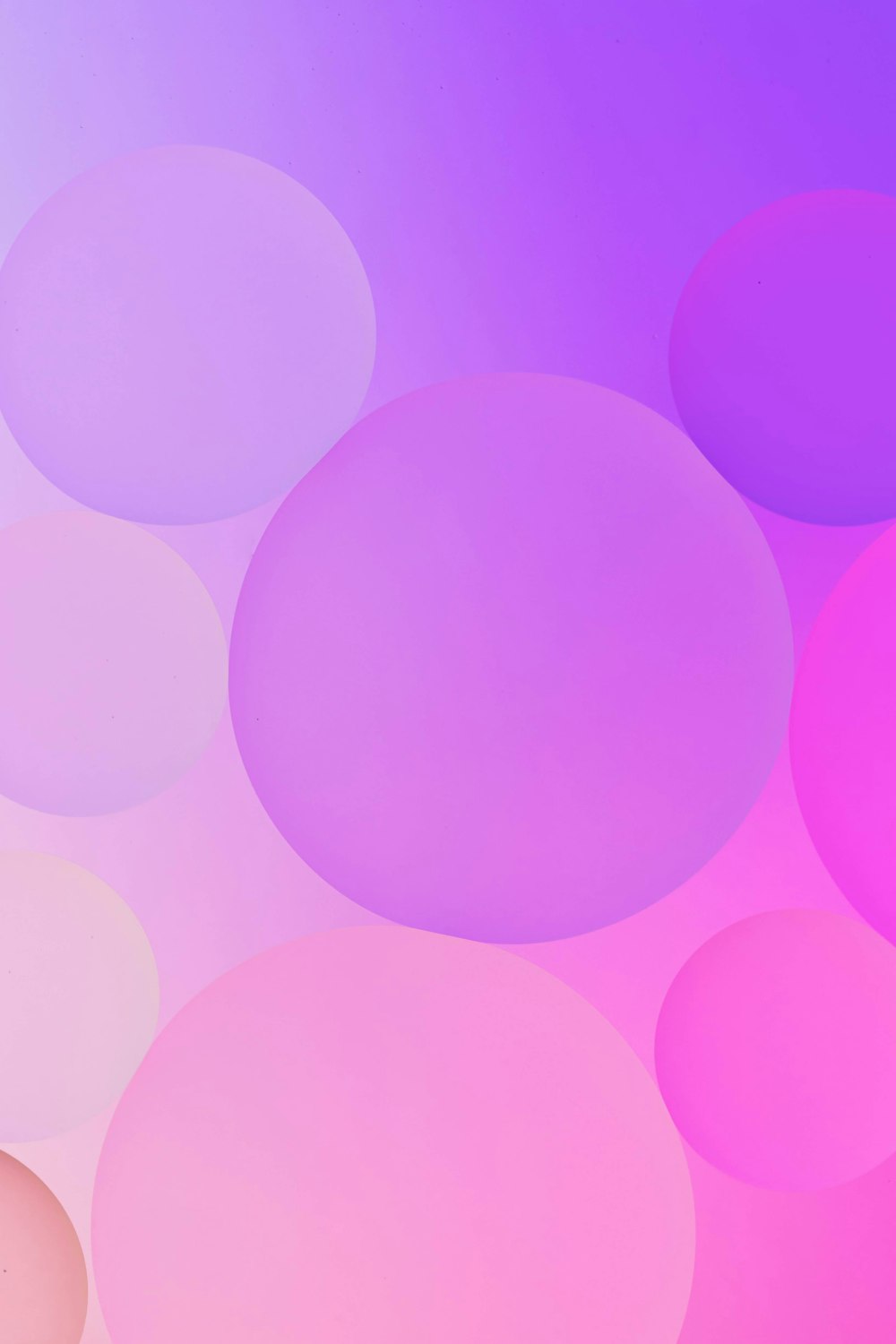 a pink and purple background with circles