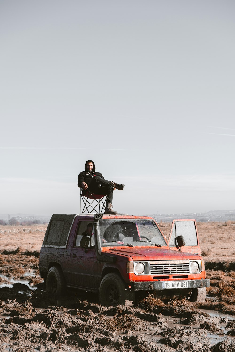 a man sitting in a chair on top of a truck