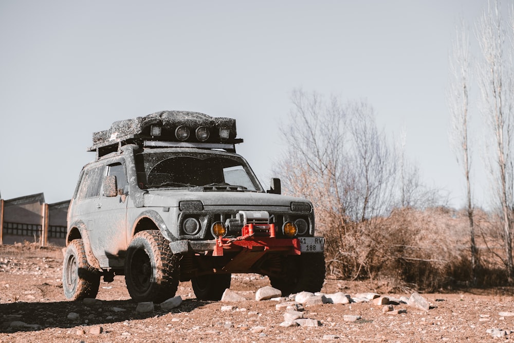 a truck parked in the middle of a dirt field