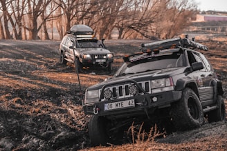a couple of cars that are in the dirt