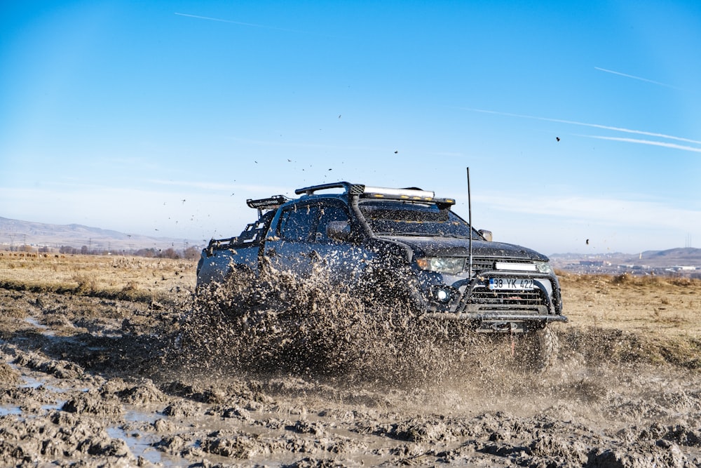 a truck driving through mud in the desert