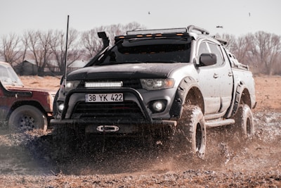 A robust pickup truck loaded with equipment, showcasing durability on a rugged Angolan road near Viana.