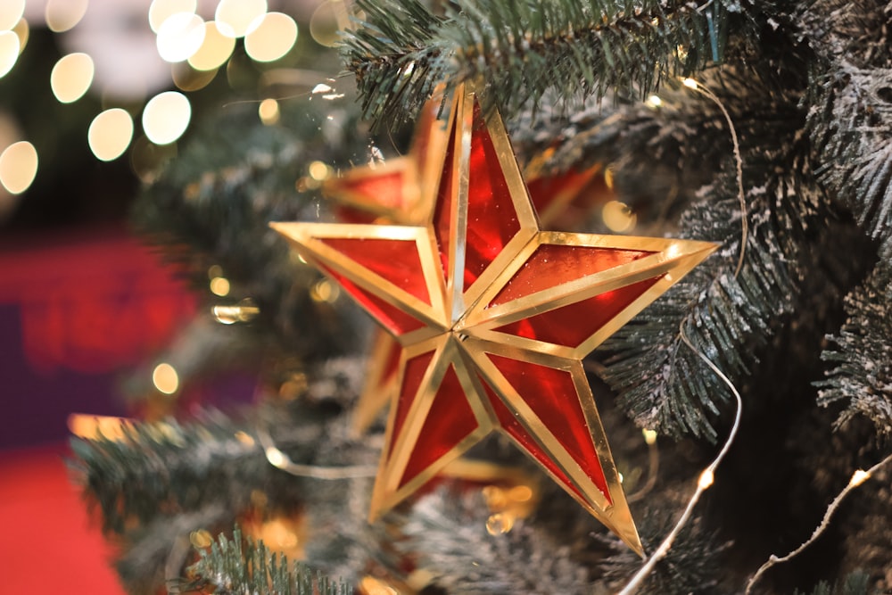 a red star hanging from a christmas tree
