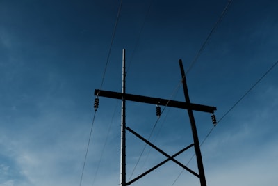 a tall metal pole sitting under a blue sky