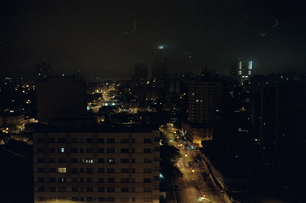 a view of a city at night from the top of a building