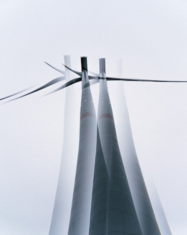 a group of wind turbines with a sky background