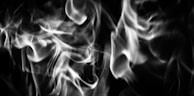 a black and white photo of smoke